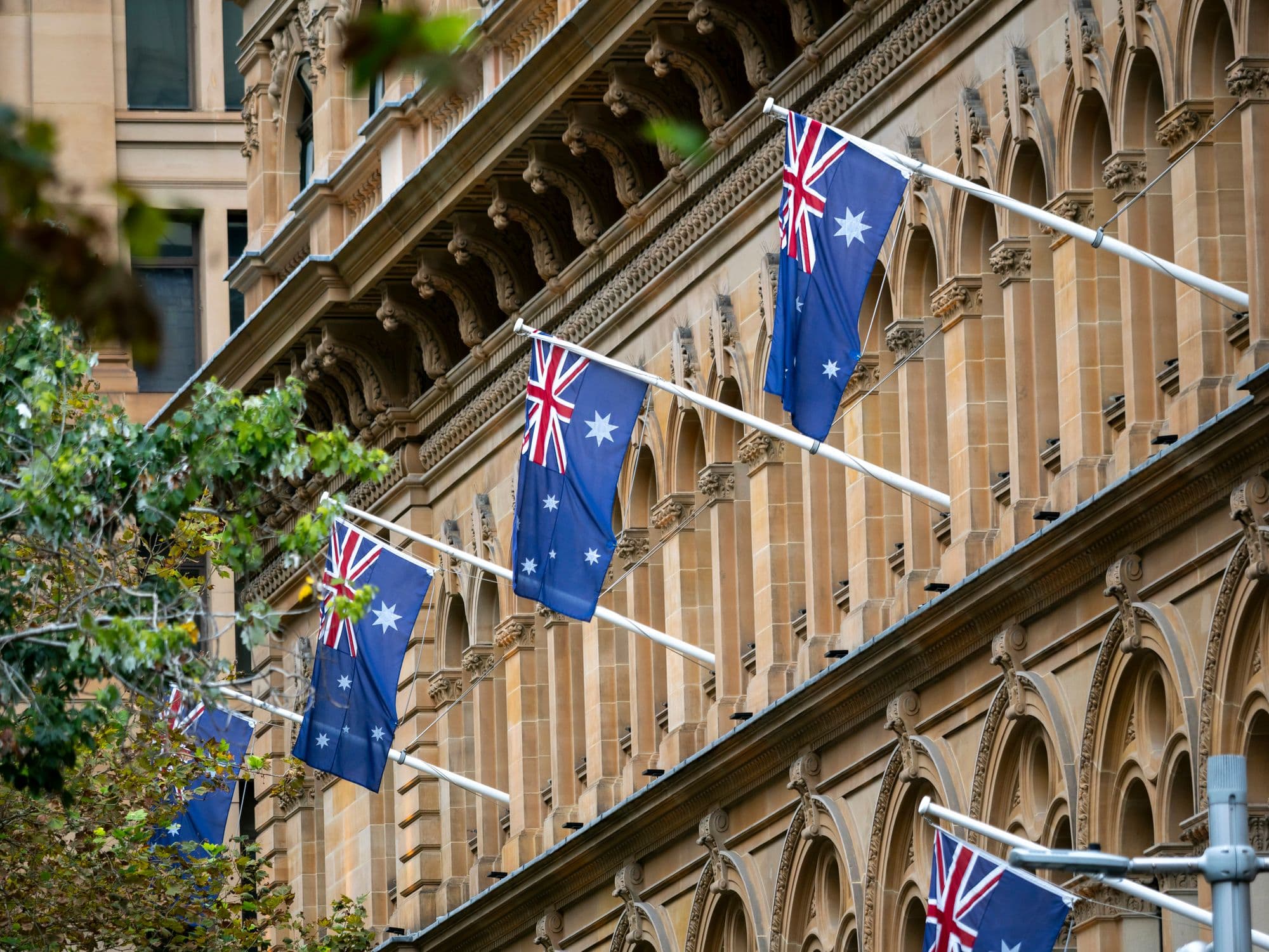 Logotipo de PointsBet superpuesto en la bandera australiana, con textos regulatorios y símbolos de reforma publicitaria en el fondo