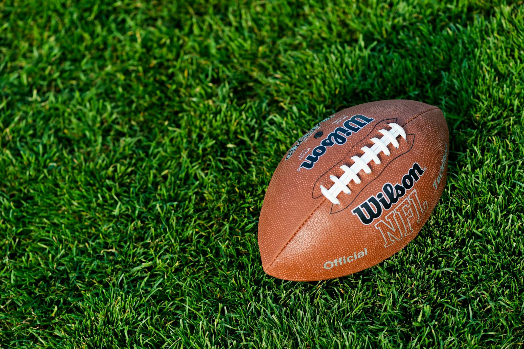 Digital chart tracking NFL betting handle and prediction market trading volumes for the US 2026 season.
