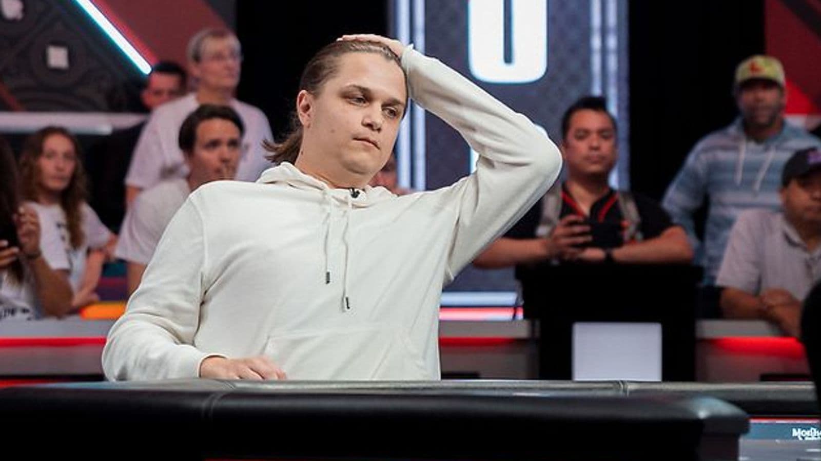 Niklas Astedt at a PokerStars online event, with WCOOP and tournament graphics in the background