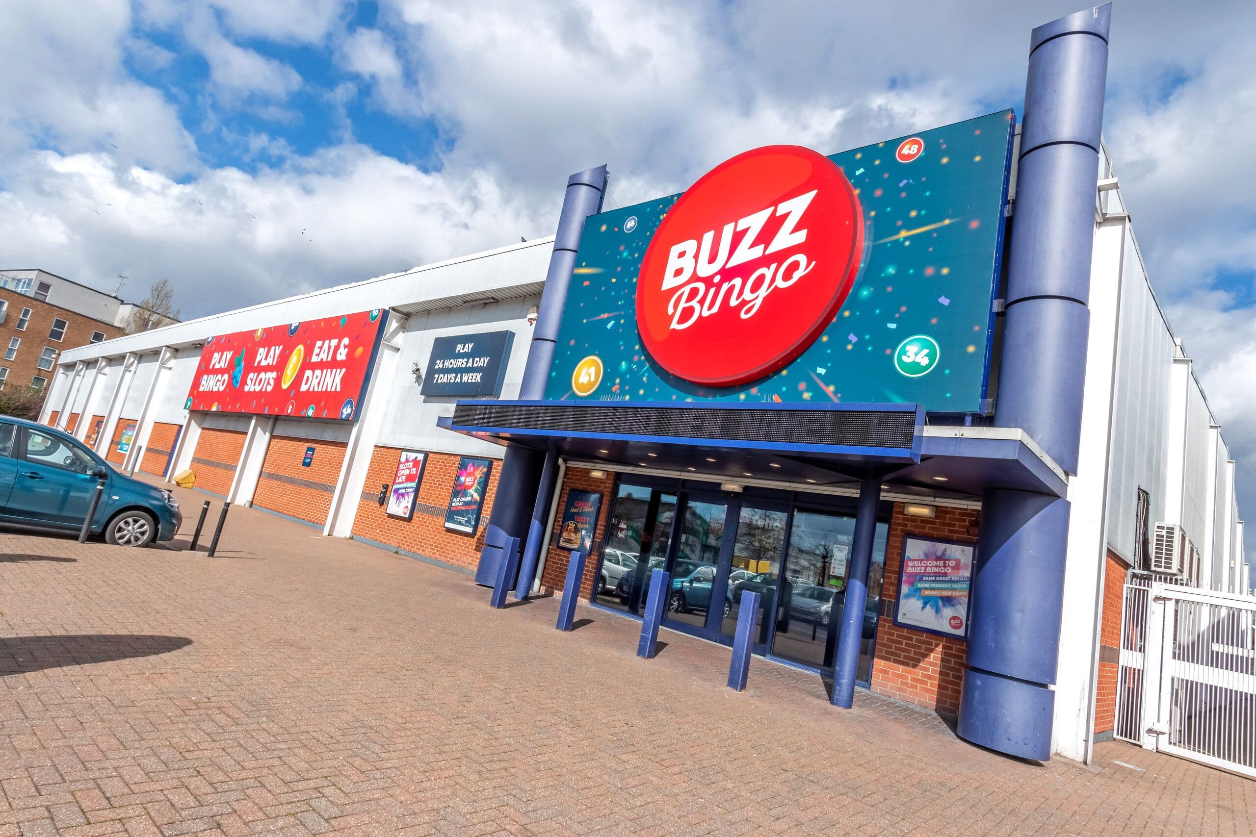 Buzz Bingo club exterior with signage and UK financial figures chart overlay