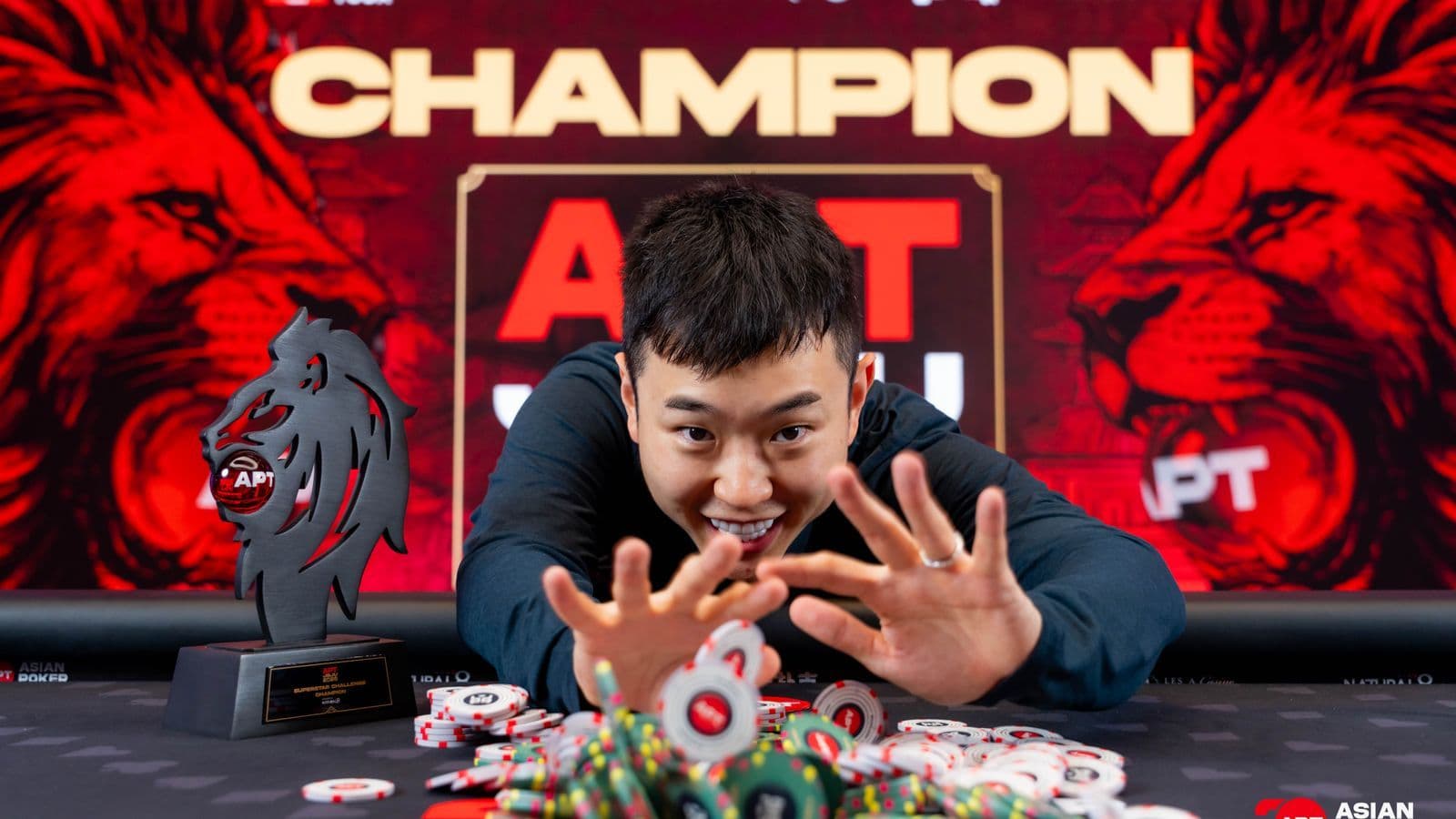 Nevan Chang at the APT Superstar Challenge final table in Jeju with stacks of chips and trophy