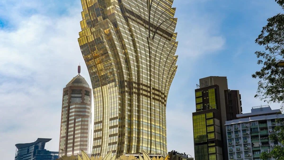 SJM Holdings interim report summary with casino skyline and financial figures overlay