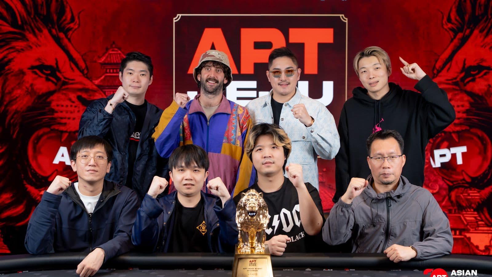 Eight poker players at a final table under lights on Jeju Island with chip stacks and tournament staff