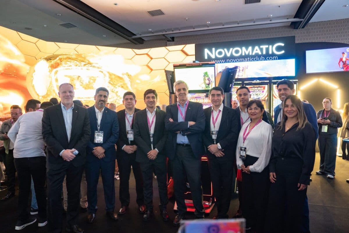 Novomatic Colombia presenting linked progressive jackpot cabinets and entry-level machines at a trade show stand in Bogotá