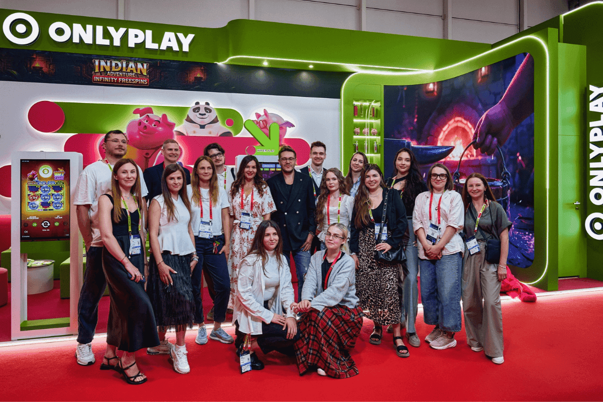 ONLYPLAY stand at SBC Summit Lisbon 2026 showing rebrand visuals, characters and Hyper Play demo