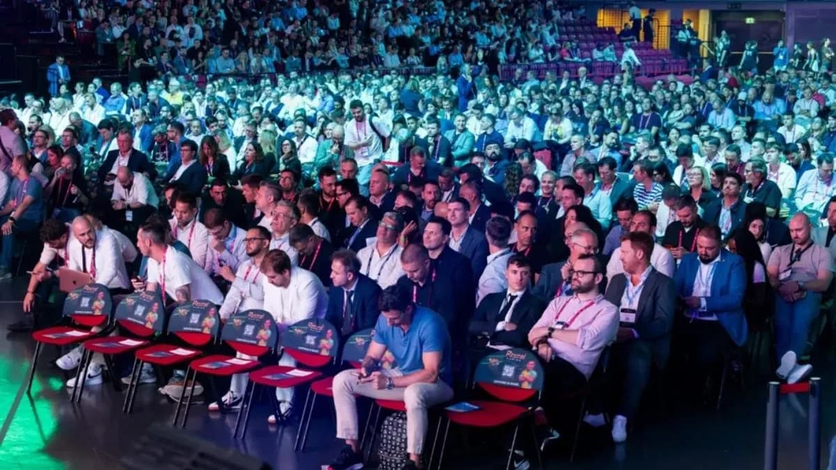 Crowded convention floor at SBC Summit Lisbon with conference stages and exhibitor booths during 2026 week
