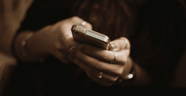 Close-up of a smartphone showing a casino balance update and instant payout notification against a blurred casino screen, emphasising fast withdrawals