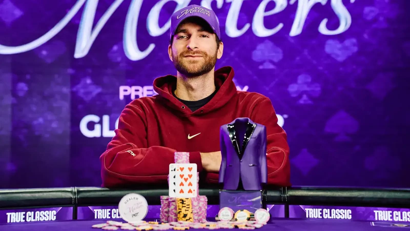 Justin Vaysman celebrating at the PokerGO Studio after winning Poker Masters Event #6 with photographers and players in the background