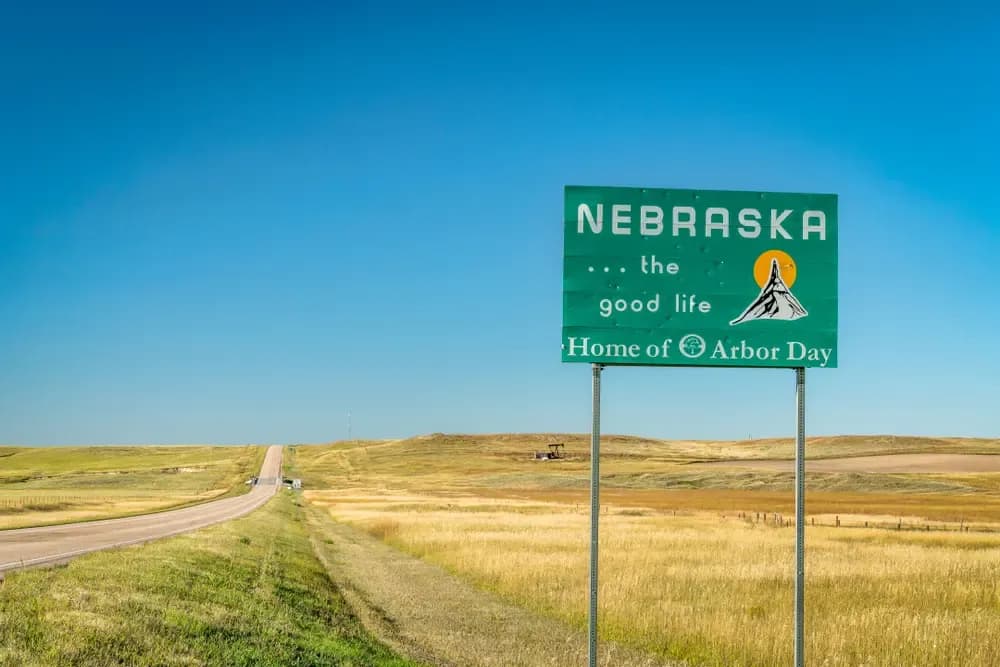Campaign signage for Nebraska sports betting alongside logos of DraftKings, FanDuel and Fanatics at a campaign event